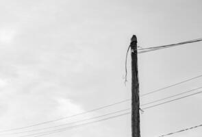 Power electric pole with line wire on light background close up photo