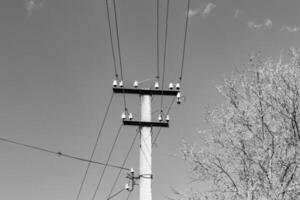 Power electric pole with line wire on light background close up photo