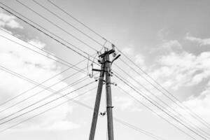 Power electric pole with line wire on dark background close up photo