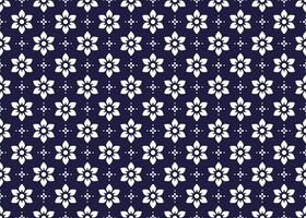 White symbol flowers on dark blue background, ethnic fabric seamless pattern design for cloth, carpet, batik, wallpaper, wrapping etc. vector