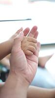 Slow motion, Close-up of a father's hand holding his son's hand. video