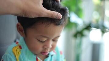 Father's hand caressing son's head, slow motion video