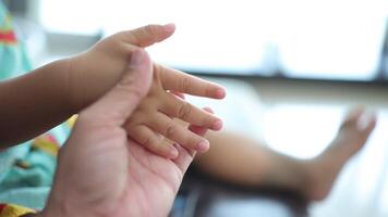 Slow motion, Close-up of a father's hand holding his son's hand. video