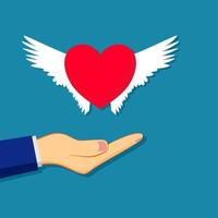 a hand holding a red heart with wings vector