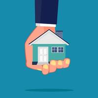 hand holding a house on blue background vector