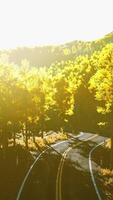 road and yellow mountain forest at sunset video