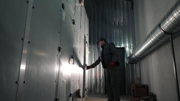 An Engineer Opens The Ventilation Shaft Door To Service The Filters Of An Industrial Ventilation Unit video