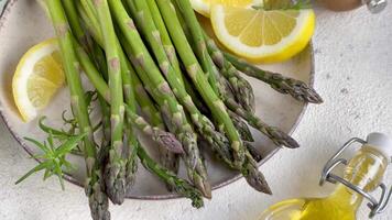 Preparing Fresh Asparagus With Lemon And Olive Oil On A Kitchen Counter video