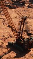 A crane is sitting in the middle of a dirt field video