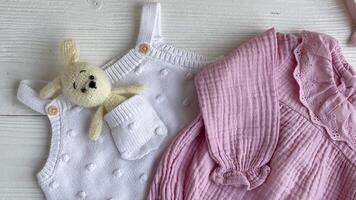 Set of pink clothes and accessories for newborn baby. video