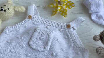 Set of white clothes and accessories for newborn baby. video