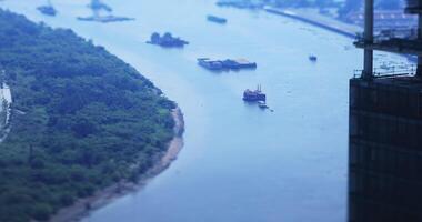 A high angle view of miniature cityscape at Saigon river in Ho Chi Minh tiltshift video