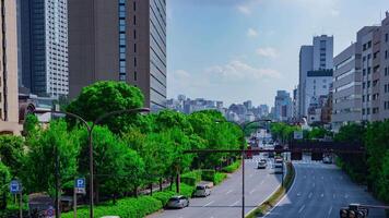 A timelapse of city street at Yasukuni avenue in Tokyo daytime wide shot panning video