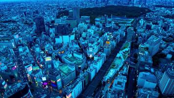 A dusk timelapse of panoramic cityscape at Shibuya area high angle wide shot tilt video