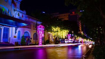 A night timelapse of neon town at Nguyen Hue street in Ho Chi Minh wide shot tilt video