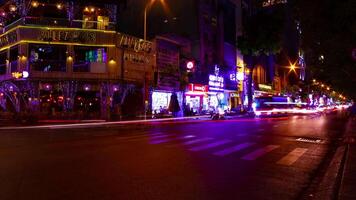A night timelapse of the neon downtown at Bui Vien street in Ho Chi Minh Vietnam wide shot tilt video