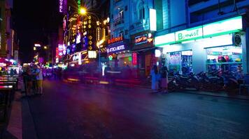 A night timelapse of the neon downtown at Bui Vien street in Ho Chi Minh Vietnam wide shot tilt video