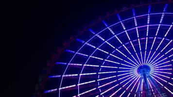 A timelapse of ferris wheel at the amusement park in Tokyo at night video