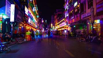 A night timelapse of the neon downtown at Bui Vien street in Ho Chi Minh Vietnam wide shot tilt video