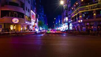 A night timelapse of the neon downtown at Bui Vien street in Ho Chi Minh Vietnam wide shot tilt video