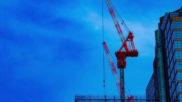 A timelapse of cranes at the under construction on the building in Tokyo video