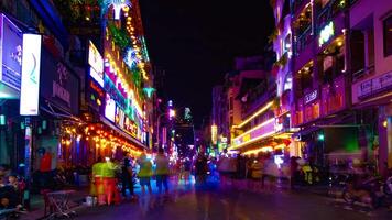 A night timelapse of the neon downtown at Bui Vien street in Ho Chi Minh Vietnam wide shot panning video