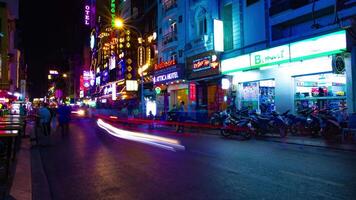 A night timelapse of the neon downtown at Bui Vien street in Ho Chi Minh Vietnam wide shot video