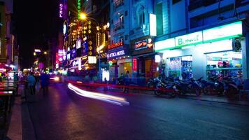 A night timelapse of the neon downtown at Bui Vien street in Ho Chi Minh Vietnam wide shot video
