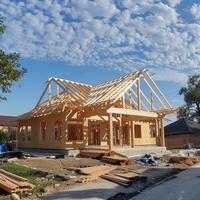 Wooden frame construction truss, posts, and beams in progress for new house manufacturing photo