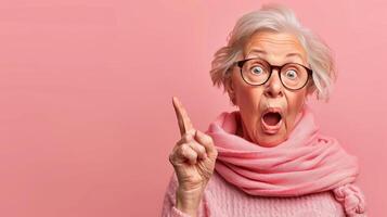 Elderly person pointing with enthusiasm on soft colored backdrop with room for text photo