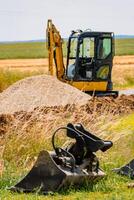 Mini digger and bucket, exterior works photo