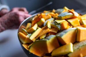 Cutting a pumpkin in the kitchen for cooking and freezing photo