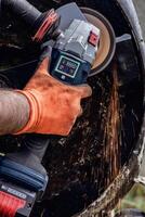 Man using portable grinder with sparkles photo