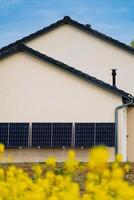 Solar panels on a well-exposed wall of an individual house, making savings following the energy crisis, eco-citizen gesture, green energy photo