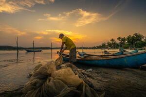 Traditional fishermen and boats in O Loan lagoon during sunset, Phu Yen province, Vietnam. Travel and landscape concept photo