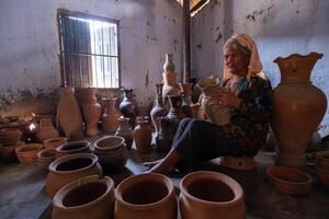 old female of Cham ethnic girl in Bau Truc pottery village, Phan Rang city, Ninh Thuan province, Vietnam. People and travel concept. photo