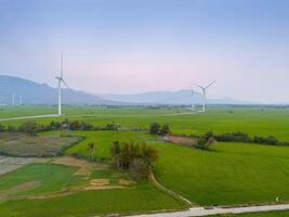 view of turbine green energy electricity, windmill for electric power production, Wind turbines generating electricity on rice field at Phan Rang, Ninh Thuan province, Vietnam photo