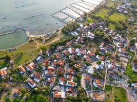 Aerial view of a peaceful village next to O Loan lagoon in sunset, Phu Yen province, Vietnam photo