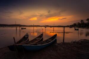 Traditional boats at O Loan lagoon in sunset, Phu Yen province, Vietnam photo