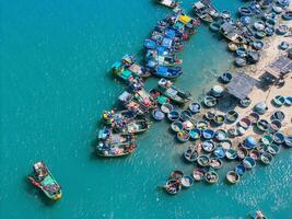 Aerial view of Loc An fishing village, Vung Tau city. A fishing port with tsunami protection concrete blocks. Cityscape and traditional boats in the sea. photo