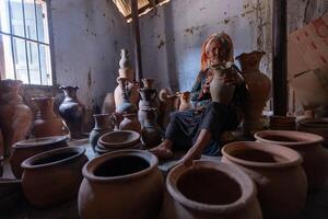 old female of Cham ethnic girl in Bau Truc pottery village, Phan Rang city, Ninh Thuan province, Vietnam. People and travel concept. photo