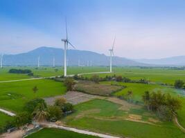 view of turbine green energy electricity, windmill for electric power production, Wind turbines generating electricity on rice field at Phan Rang, Ninh Thuan province, Vietnam photo