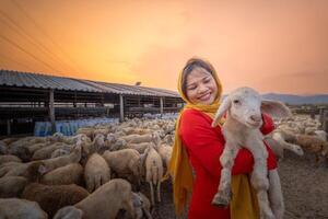 vietnamita mujer con Cordero en un campo, un oveja granja en el estepa zona en ninh Thuan provincia, Vietnam. foto