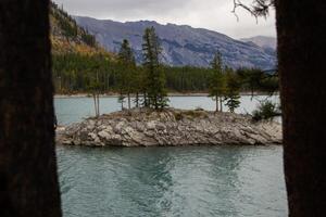 Cloudy Day on Rocky Island in Lake Minnewanka, Canadian Rocky Mountains, Banff National Park photo