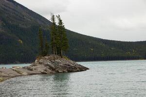 Cloudy Day on Rocky Island in Lake Minnewanka, Canadian Rocky Mountains, Banff National Park photo