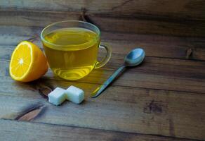 Green tea in a mug, lemon, sugar and a spoon. photo