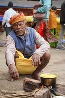 15th January 2023, Kolkata, West Bengal, India. Portrait of Visitor Cooking Food at Kolkata Ganga Sagar Transit Camp photo