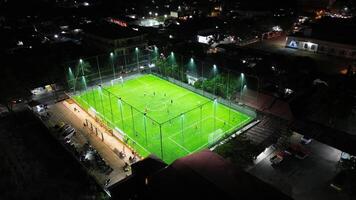 Aerial view of mini football match, soccer. MiniFootball field and Footballers from drone photo