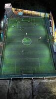 Aerial view of mini football match, soccer. MiniFootball field and Footballers from drone photo