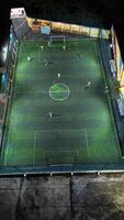 Aerial view of mini football match, soccer. MiniFootball field and Footballers from drone photo